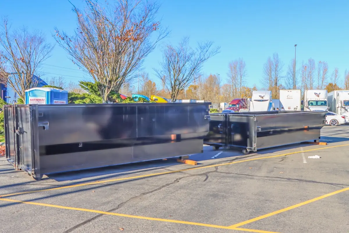 Professional dumpster rental service with roll-off container on residential driveway in Searcy